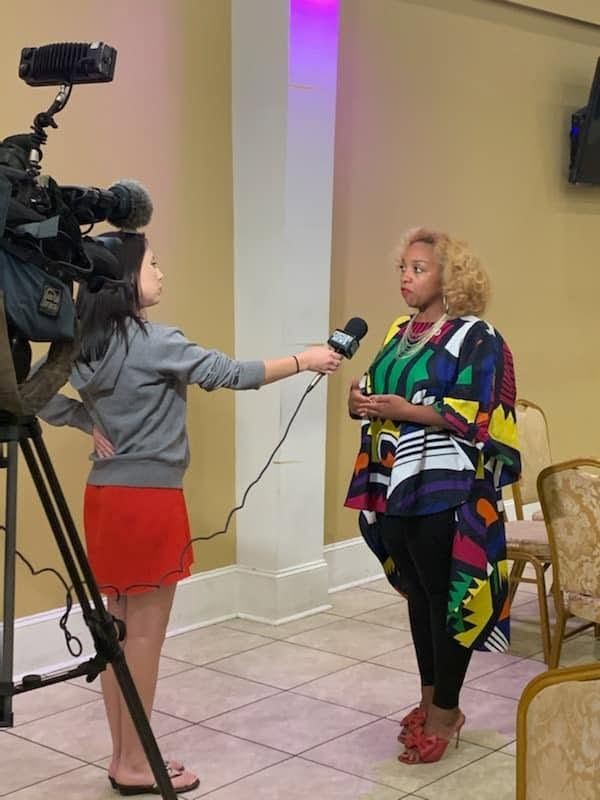 Candace N. Newell being interviewed by local media